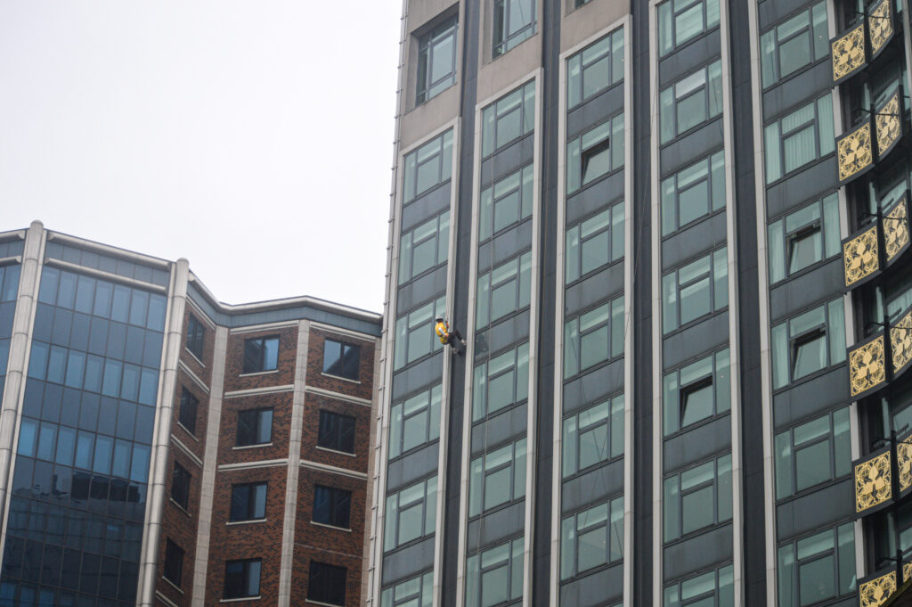 A view of the team abseil from the ground outside the Europa Hotel, Belfast.